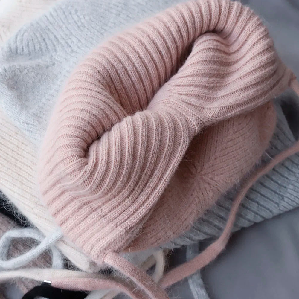 Close-up of a pink knitted Kawaii beanie on a neutral background