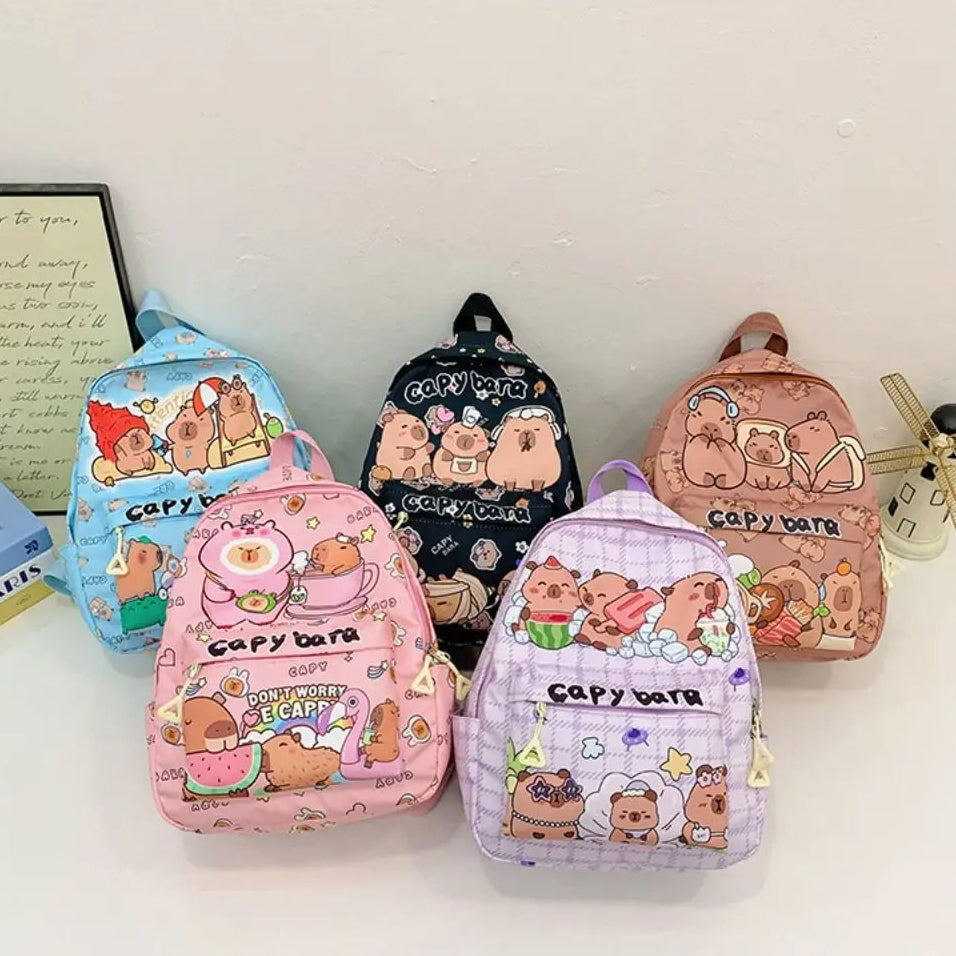 Five small backpacks with Kawaii cartoon character designs on a white surface.