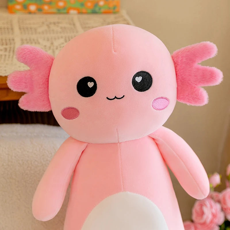 Pink axolotl kawaii plush toy with a cute face on a blurred background