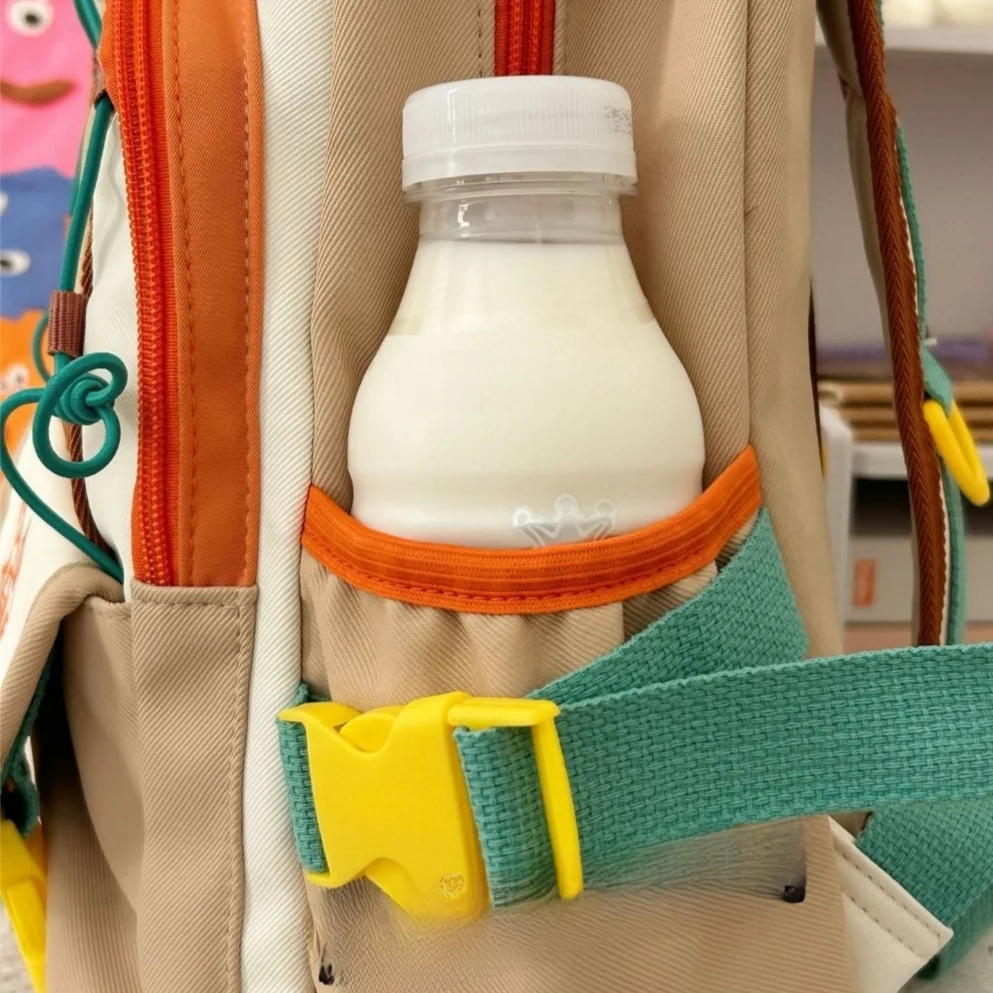 Milk bottle in a Kawaii colorful backpack with a yellow buckle