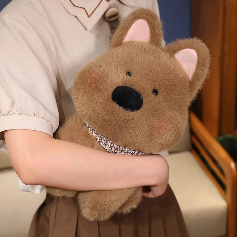 Person holding a brown kawaii teddy bear with a checkered ribbon in a cozy indoor setting