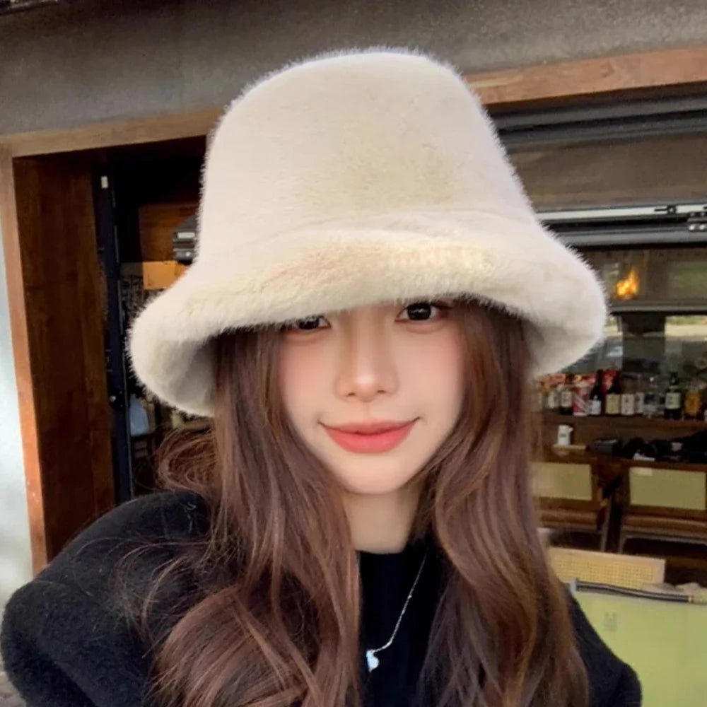 Person wearing a fluffy Kawaii beige bucket hat indoors.