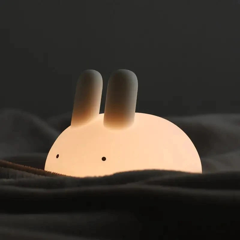 Cute rabbit-shaped kawaii night light on a dark background
