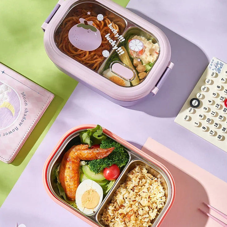 Two kawaii bento boxes with food on a colorful surface