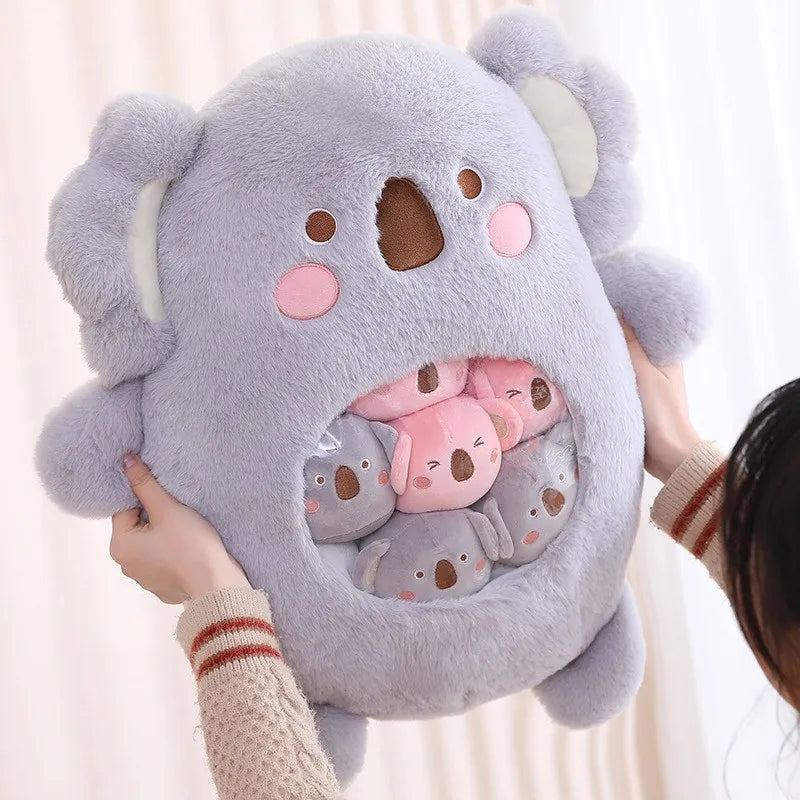 Kawaii plush toy shaped like a koala with multiple smaller koala plushies inside, held by a person.