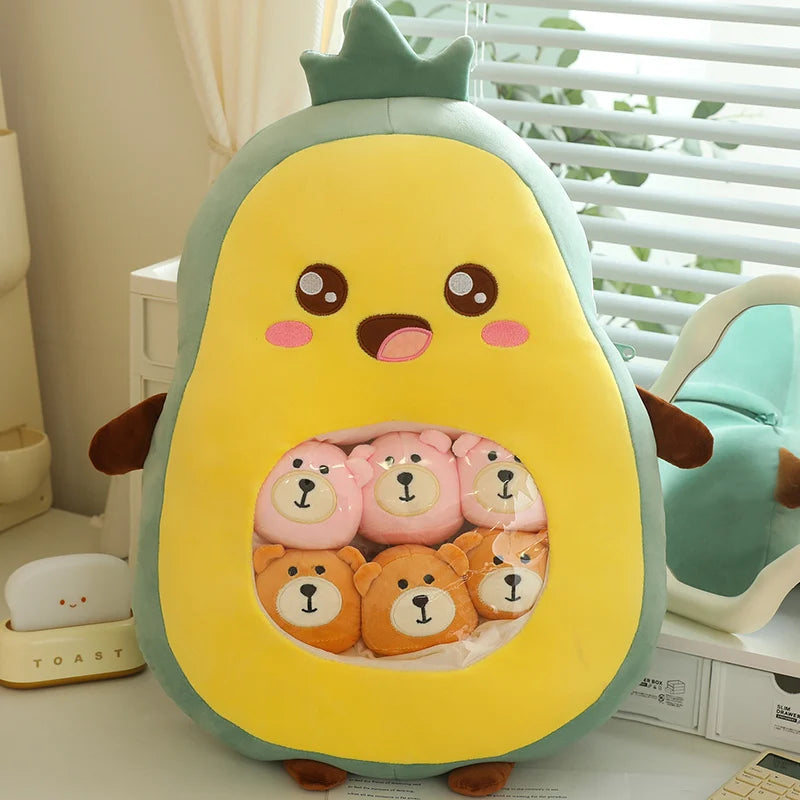 Avocado-shaped kawaii plush toy with bear faces inside, on a light-colored surface.