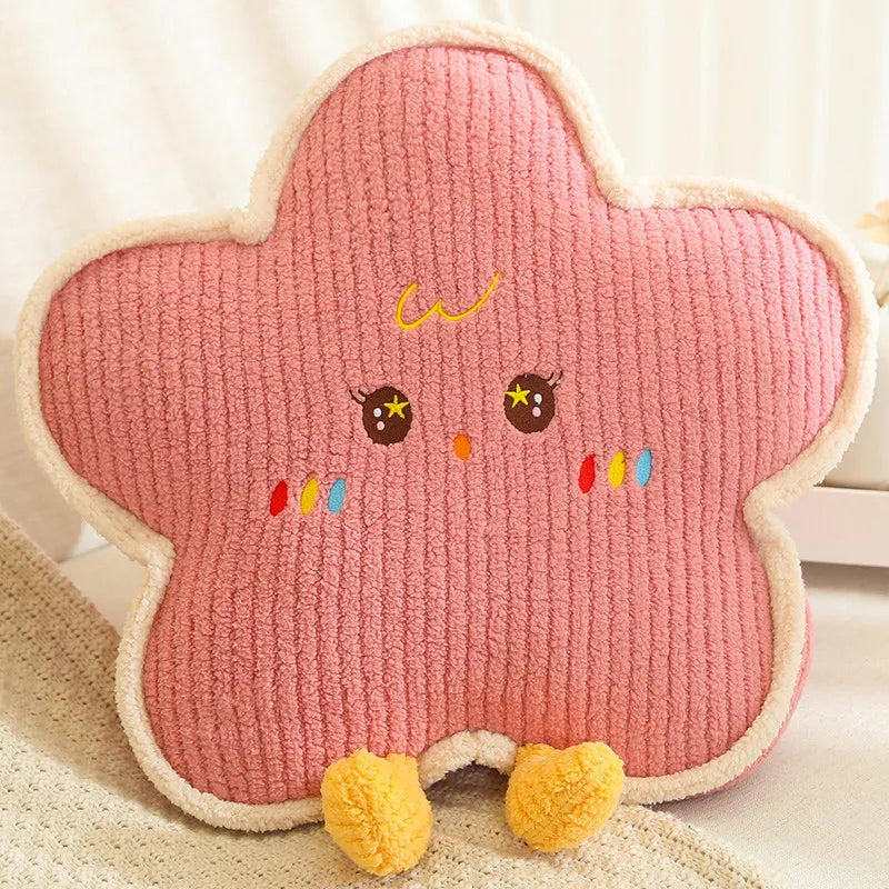 Pink star-shaped kawaii cushion with cartoon face and colorful details on a light background