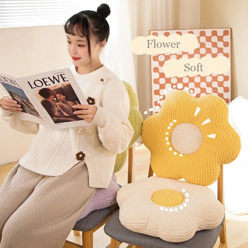 Woman reading a magazine next to a yellow flower-shaped kawaii cushion on a chair.