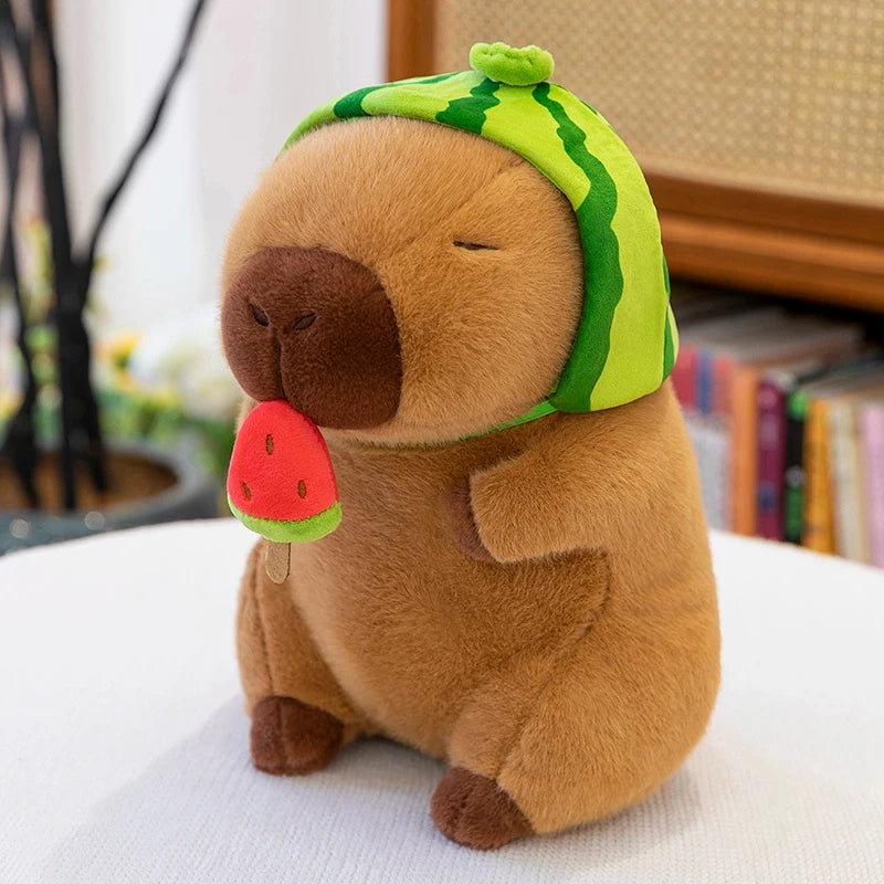 Kawaii plush toy dog wearing a watermelon hat and holding a watermelon slice on a white surface.