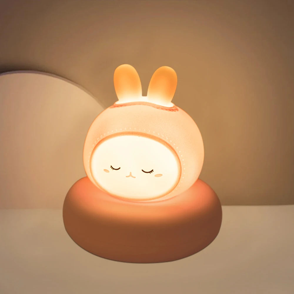 Cute kawaii rabbit-shaped night light emitting a warm glow on a neutral background