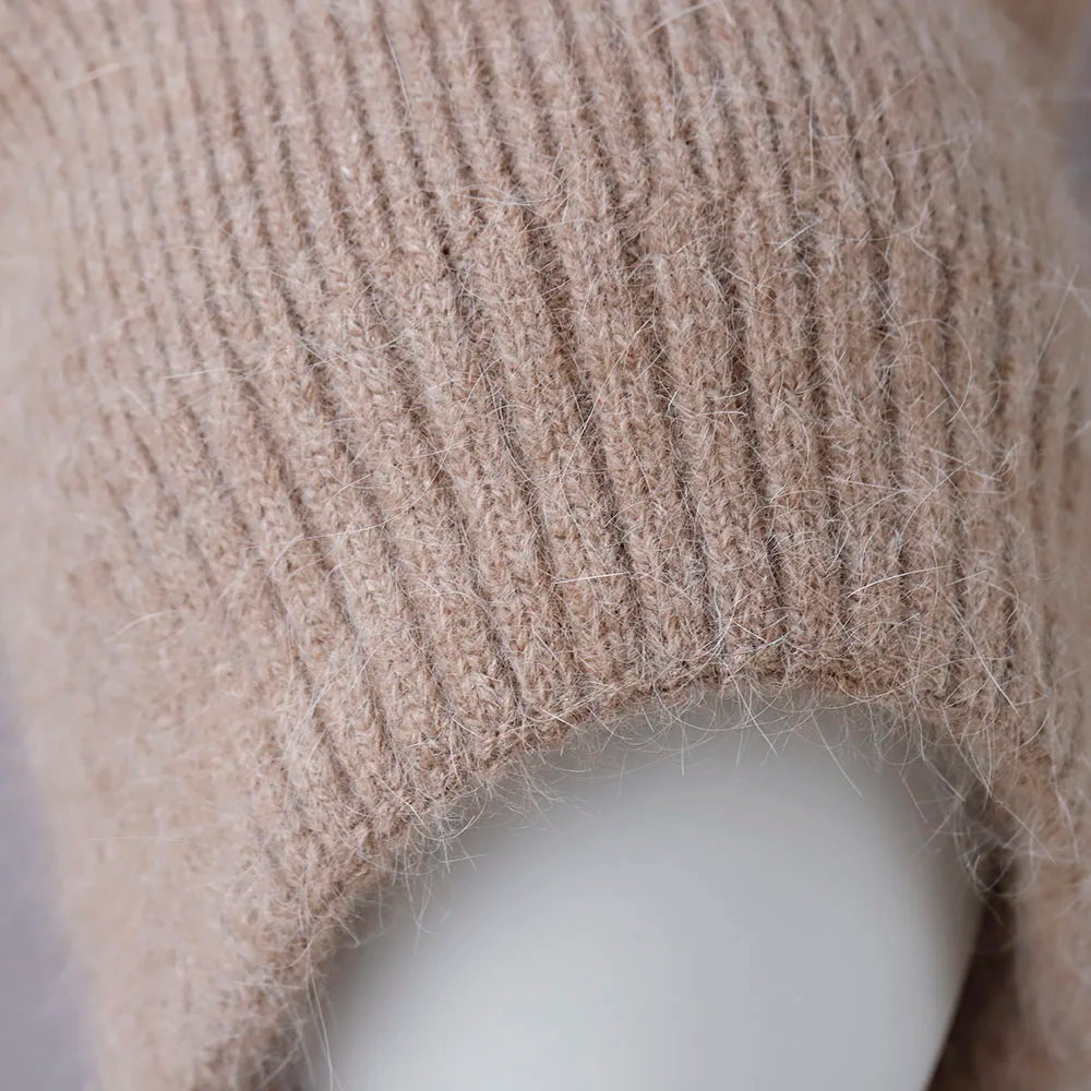 Close-up of a beige knitted Kawaii hat on a mannequin against a neutral background