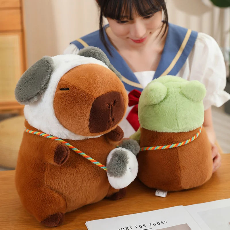 Two kawaii plush toys resembling dogs on a table with a person in a school uniform in the background.