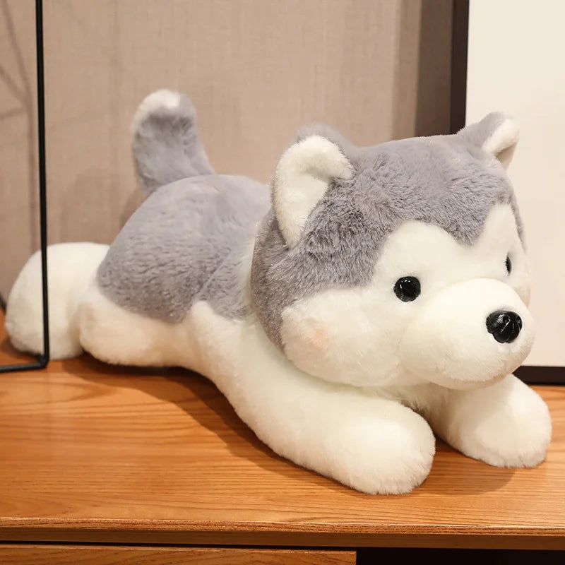 Plush kawaii toy husky dog on a wooden surface with a neutral background