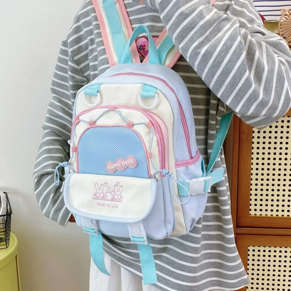Person wearing a Kawaii pastel-colored backpack with visible branding