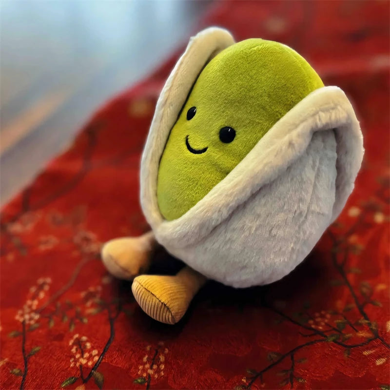 Plush kawaii toy resembling a pistachio on a red floral background
