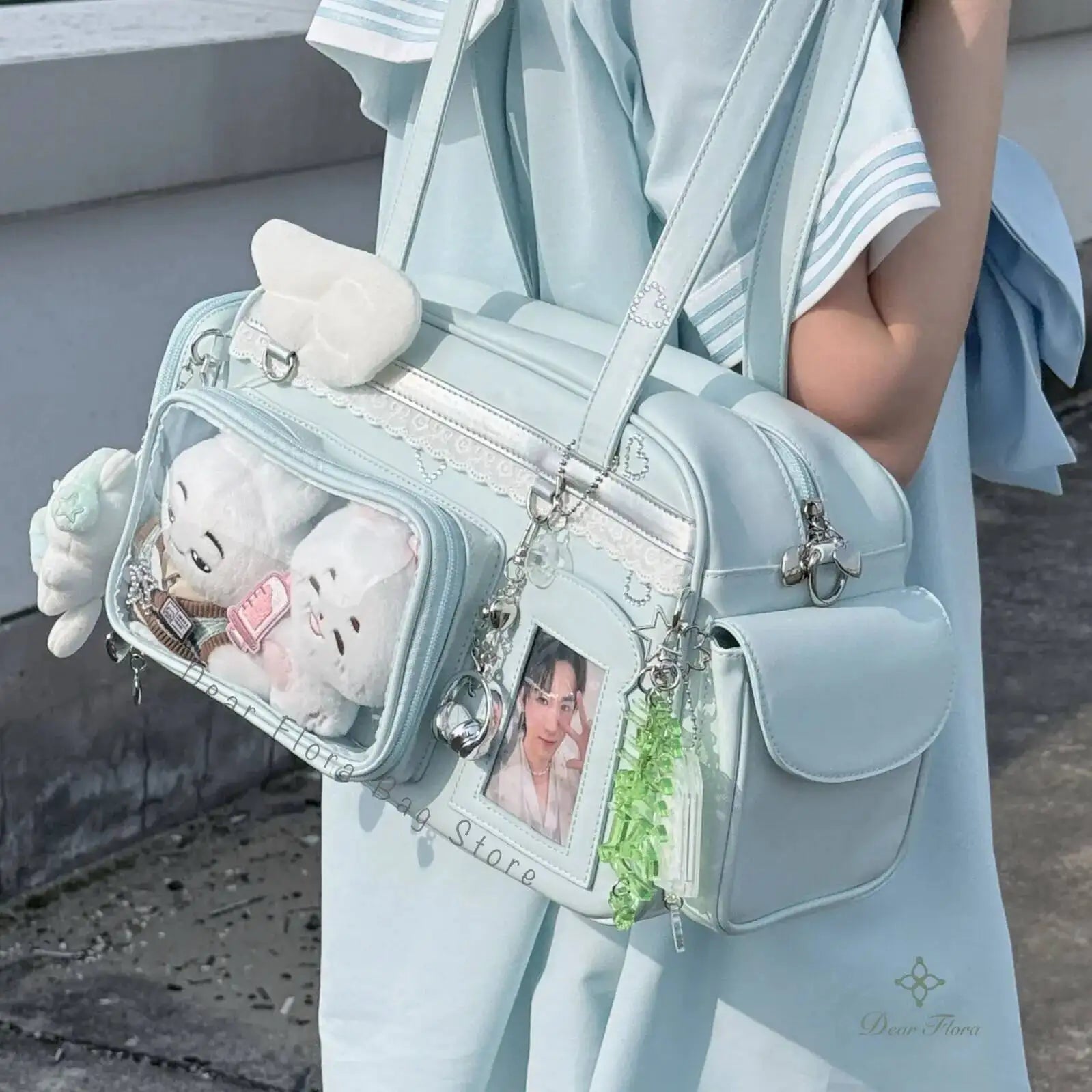 Light blue Kawaii handbag with plush toy and photo frame details, held by a person in light blue outfit.