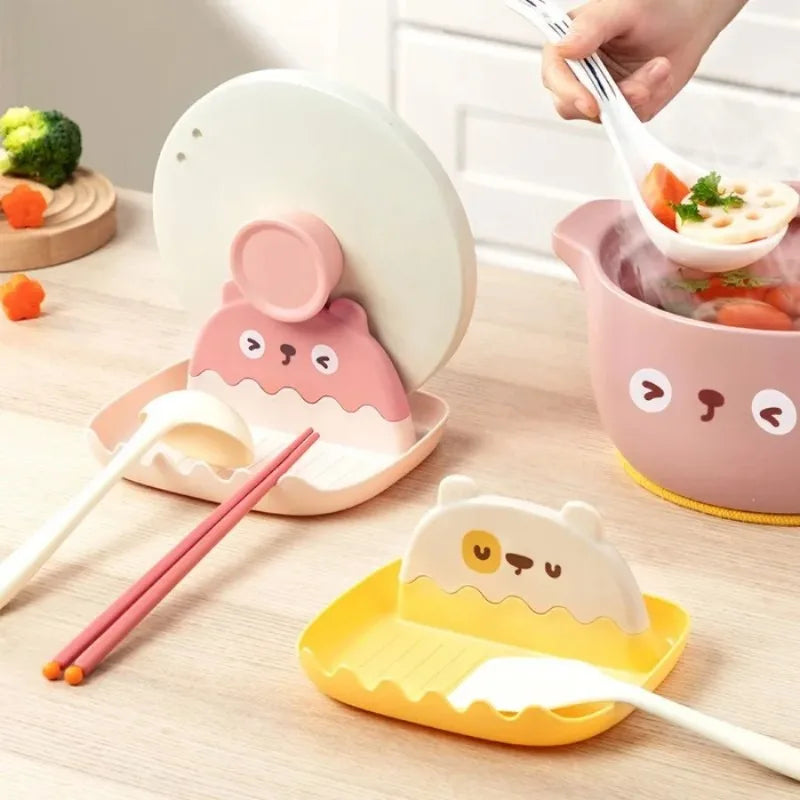Cute ceramic bowls with kawaii animal faces on a table with utensils