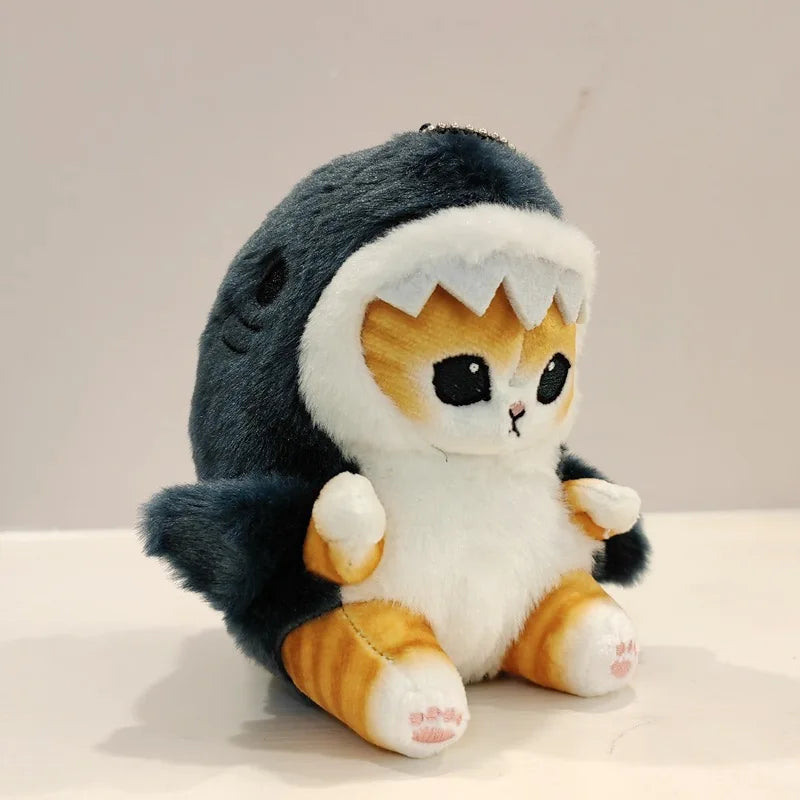 Plush kawaii toy resembling a cat in a shark costume on a neutral background
