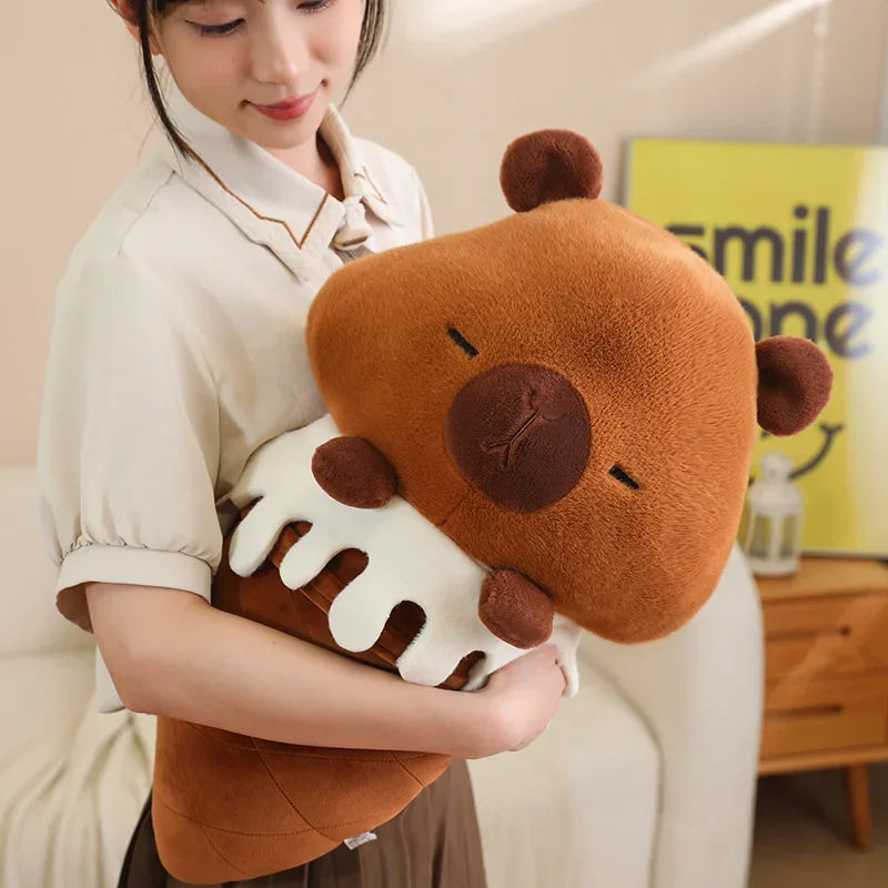 Person holding a large brown kawaii teddy bear plush toy in a living room setting.