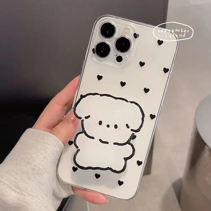 Phone case with a kawaii cartoon dog design and heart patterns held by a person.