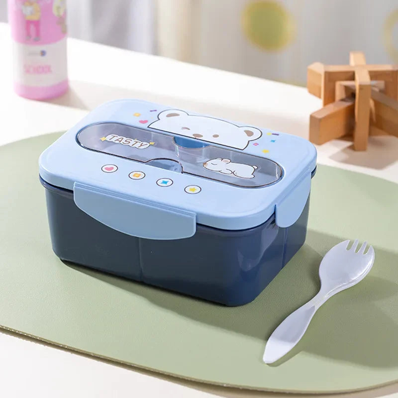 Blue lunch box with kawaii cartoon design on a green surface, accompanied by a white fork.