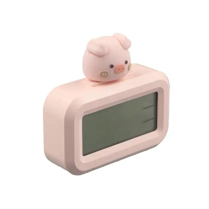 Pink kawaii digital clock with a piggy-shaped figure on top against a white background