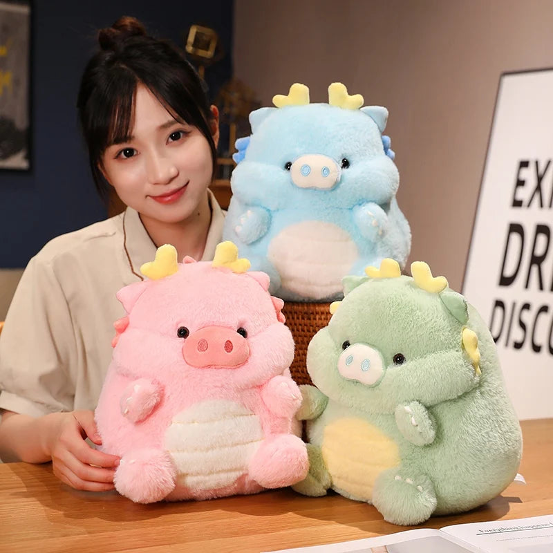 Woman holding three colorful kawaii plush dragon toys on a table.