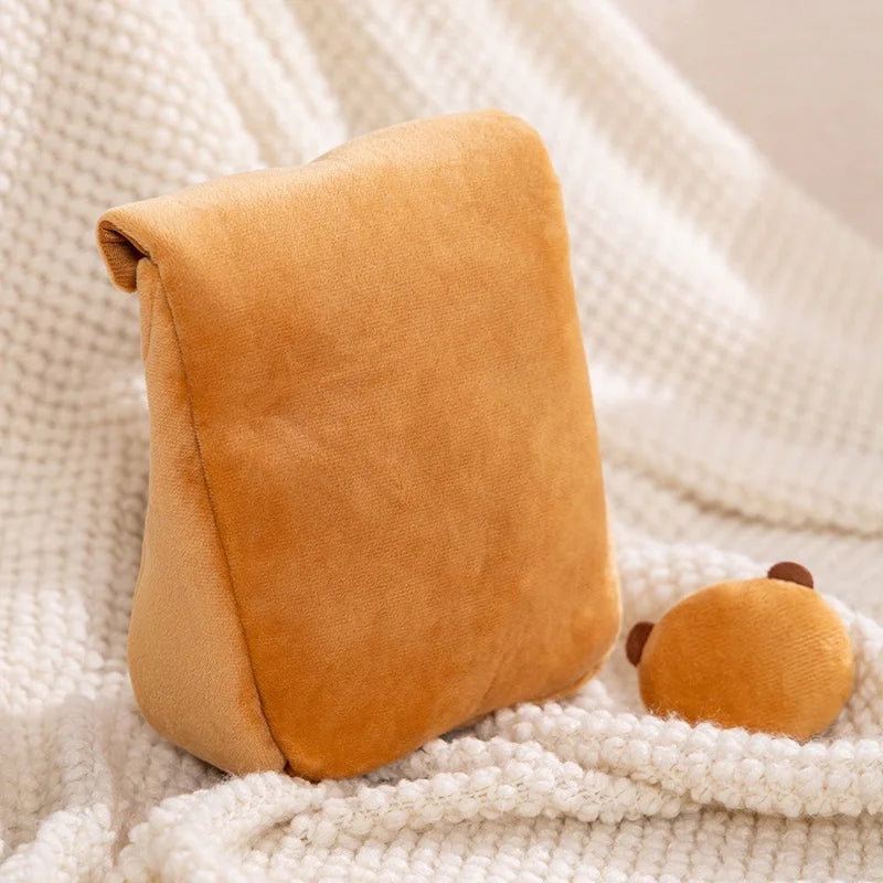 Brown wedge-shaped kawaii pillow on a soft white blanket