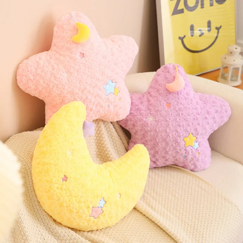 Star, moon, and cloud-shaped kawaii cushions on a couch with a smiley face poster in the background.