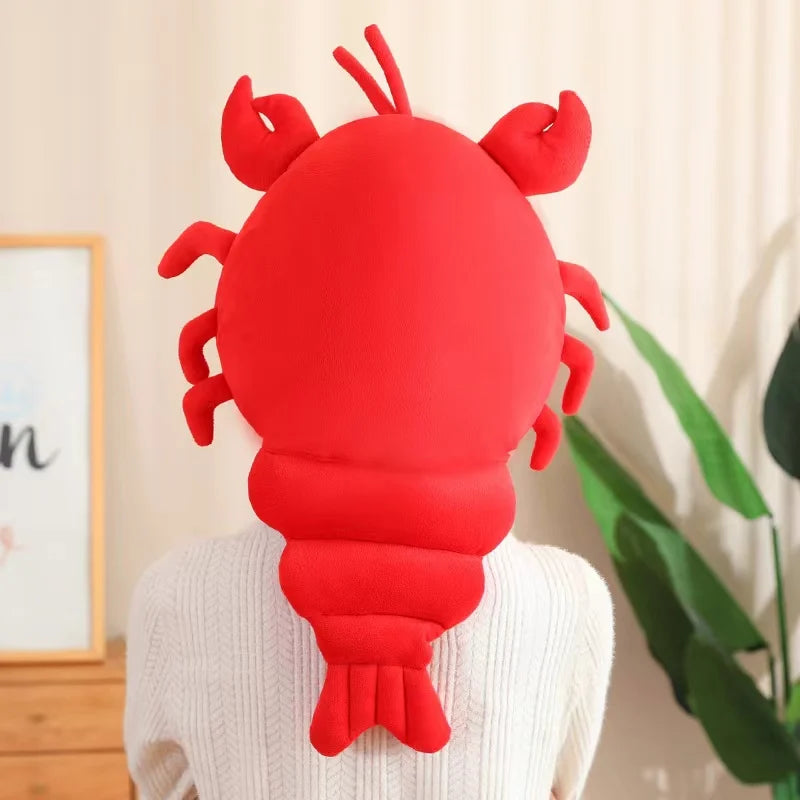 Red lobster-shaped kawaii pillow on a person's shoulder with a neutral background