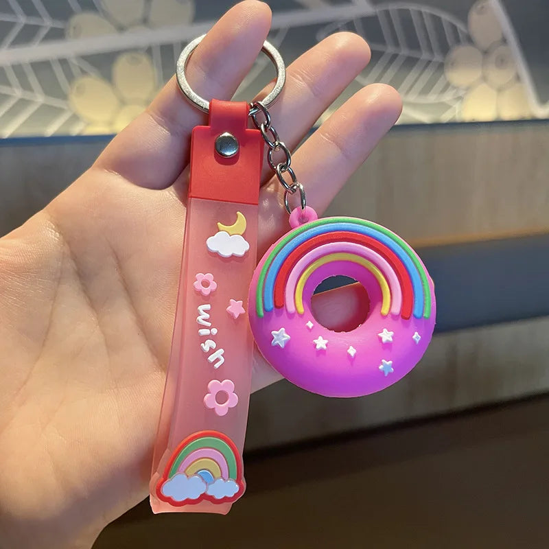 Colorful kawaii keychain with rainbow design held by a hand