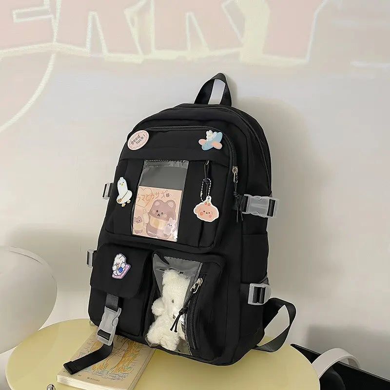 Kawaii black backpack with decorative elements on a white surface