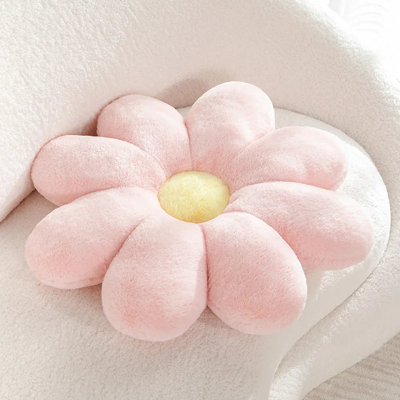 Pink flower-shaped Kawaii cushion with a yellow center on a light background
