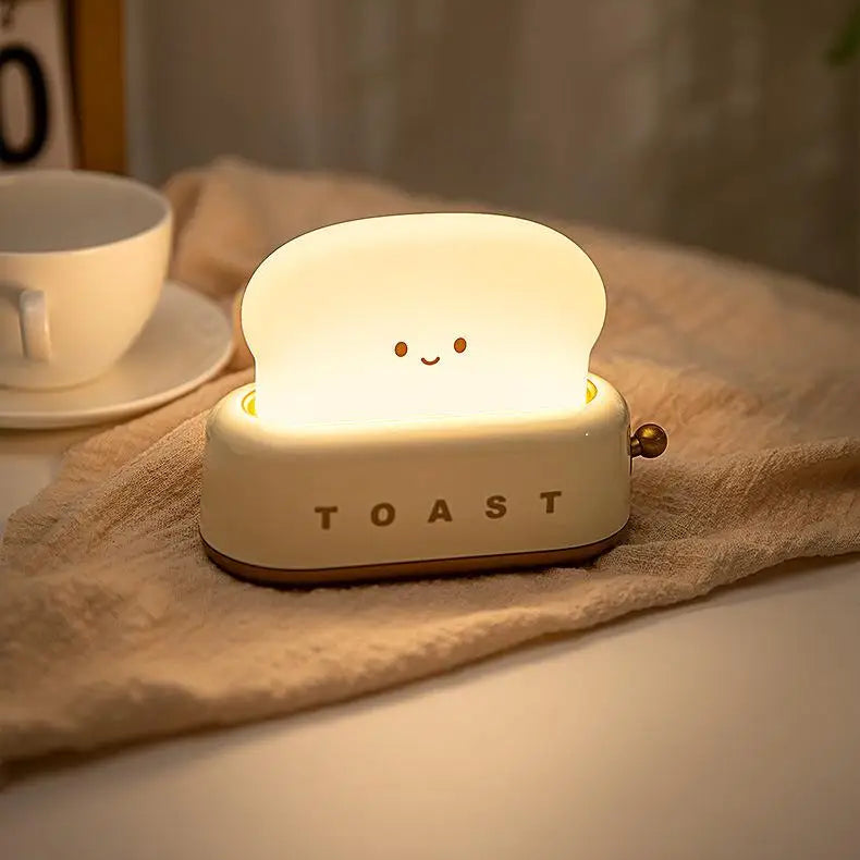 Kawaii toy toaster with a smiling face on a tablecloth