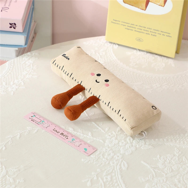 Beige kawaii plush toy with brown legs and a smiley face on a textured surface.