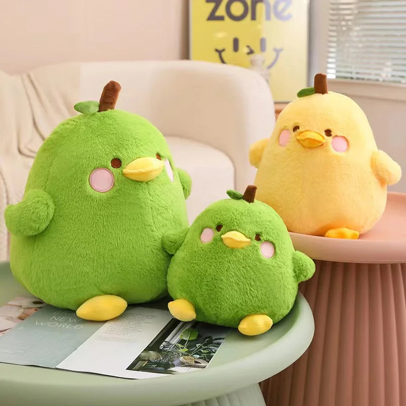 Three colorful kawaii plush toys resembling birds on a table with a light-colored couch in the background.
