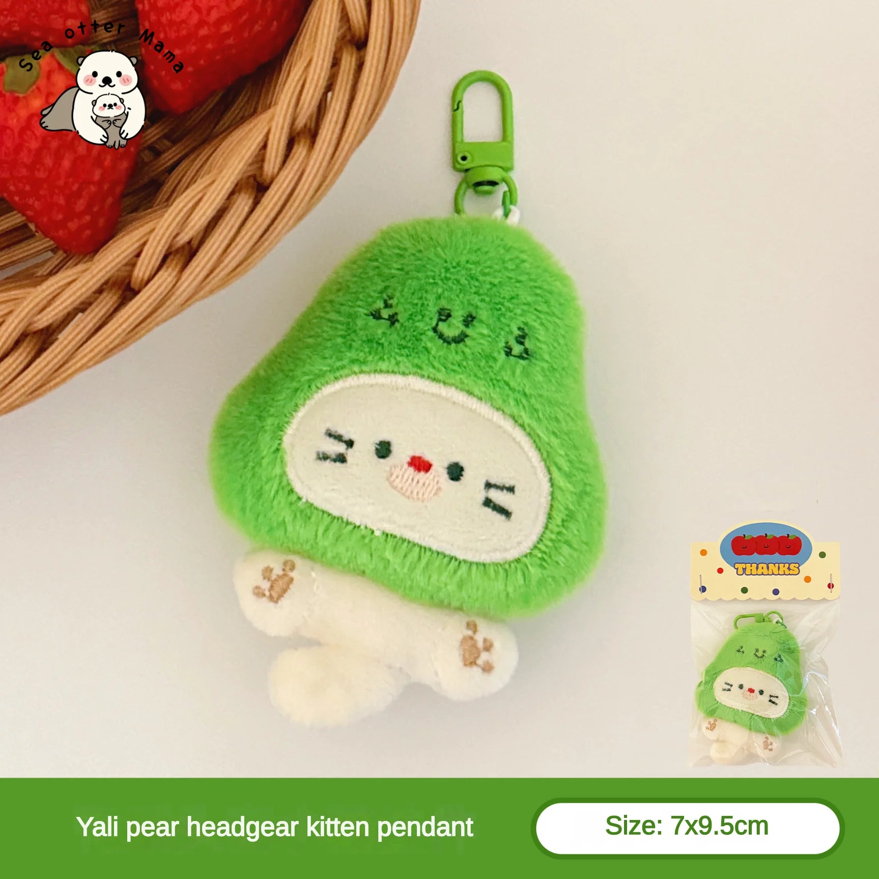 Green plush kawaii kitten pendant with a basket of strawberries in the background