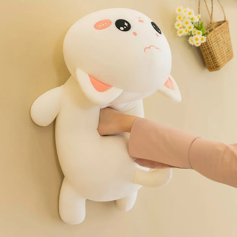 Cute plush toy resembling a kawaii cartoon character held by a person against a beige wall.