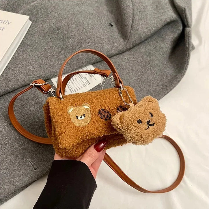 Brown Kawaii teddy bear-shaped handbag with a matching keychain held by a hand.