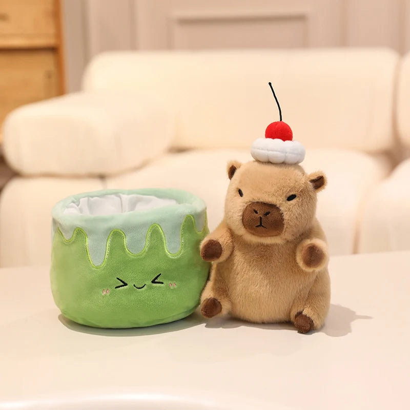 Kawaii plush toy resembling a bear with a cherry on top next to a green container with a face on a beige couch.