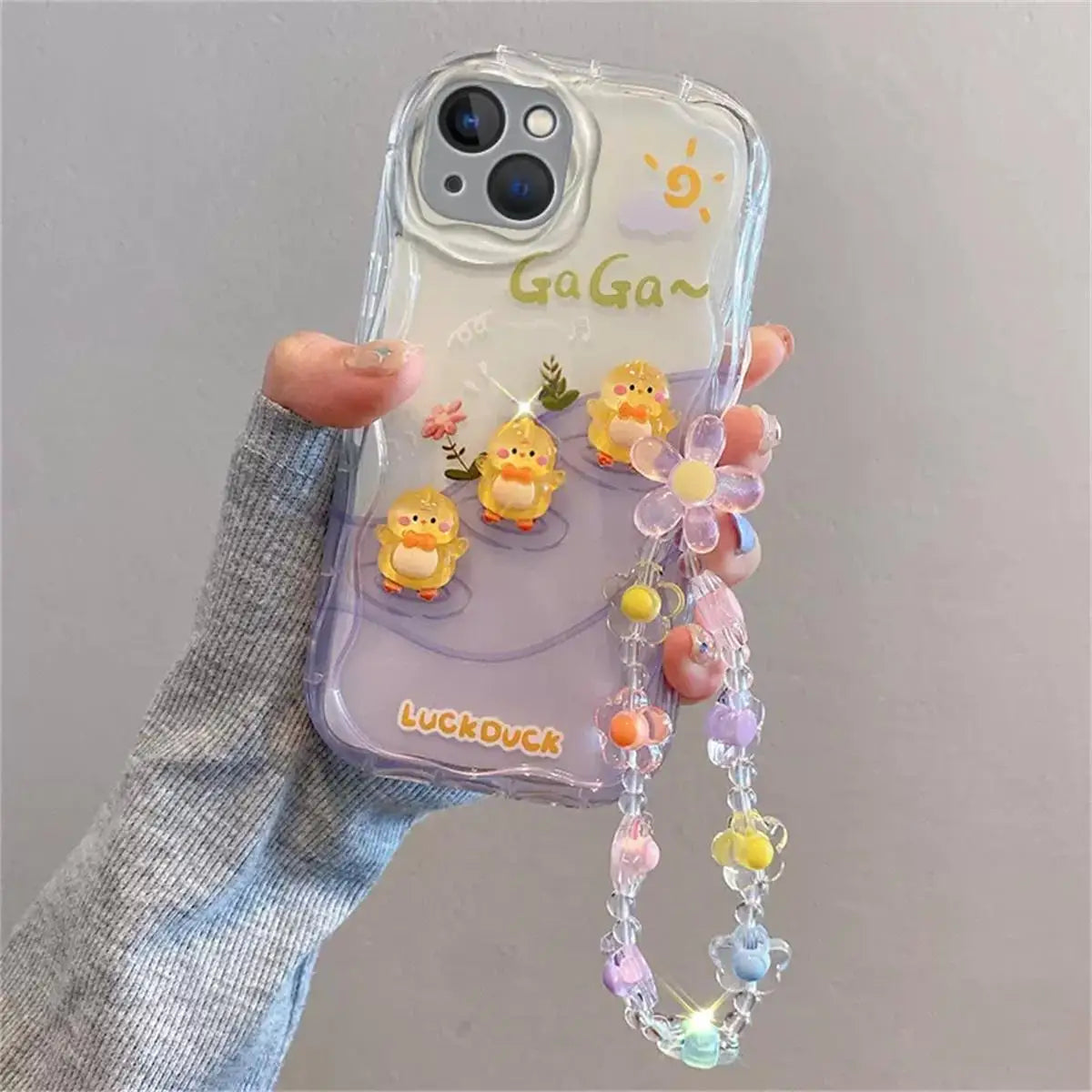 Phone case with kawaii colorful charm and 'Ga Ga~' text on a gray background