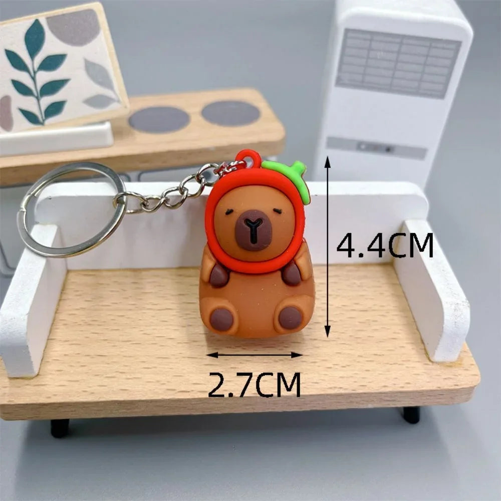 Keychain with kawaii bear design and measurements on a wooden stand