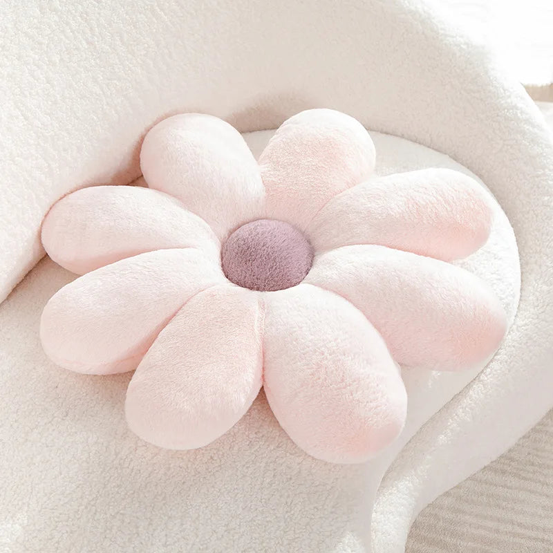 Kawaii floral-shaped cushion with pink petals and a purple center on a soft beige background