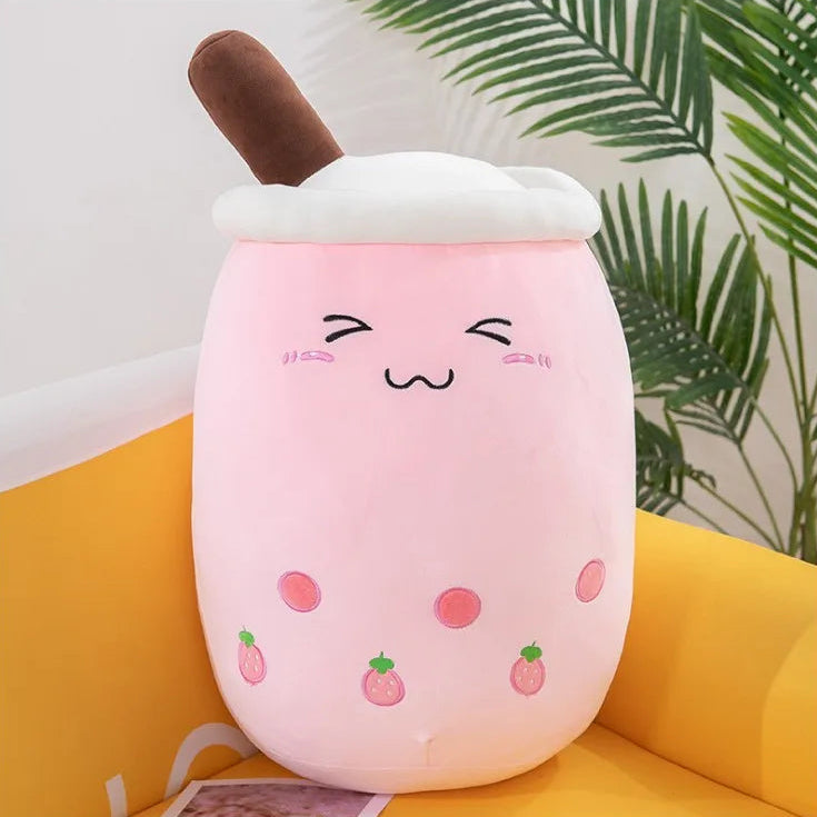 Plush kawaii toy resembling a pink ice cream with a brown cone on a yellow surface.