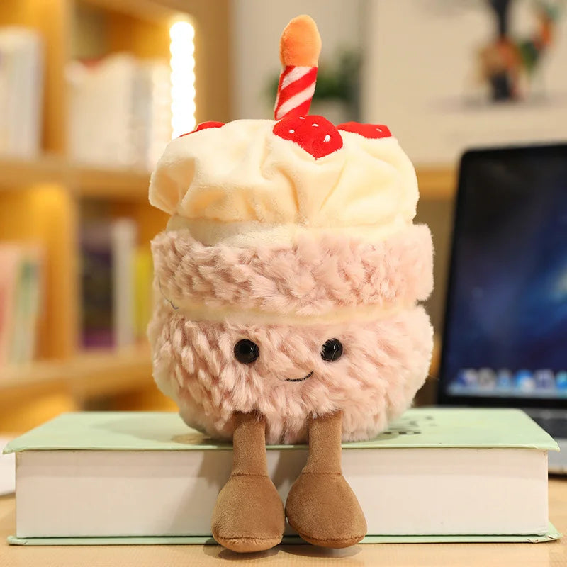 Plush kawaii toy resembling a layered dessert with a candle on a book