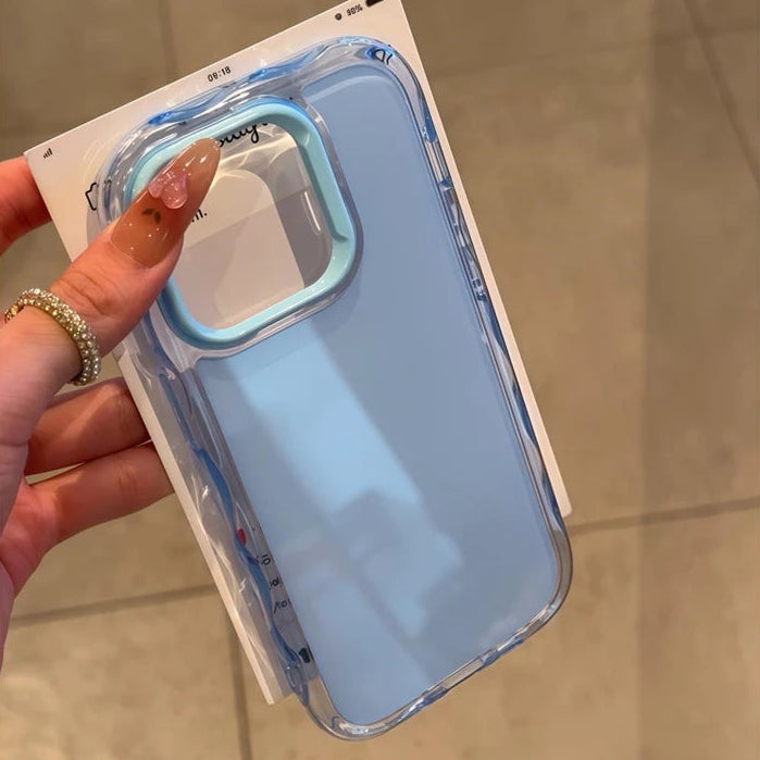 Clear kawaii phone case with blue accents held by a hand on a tiled floor background