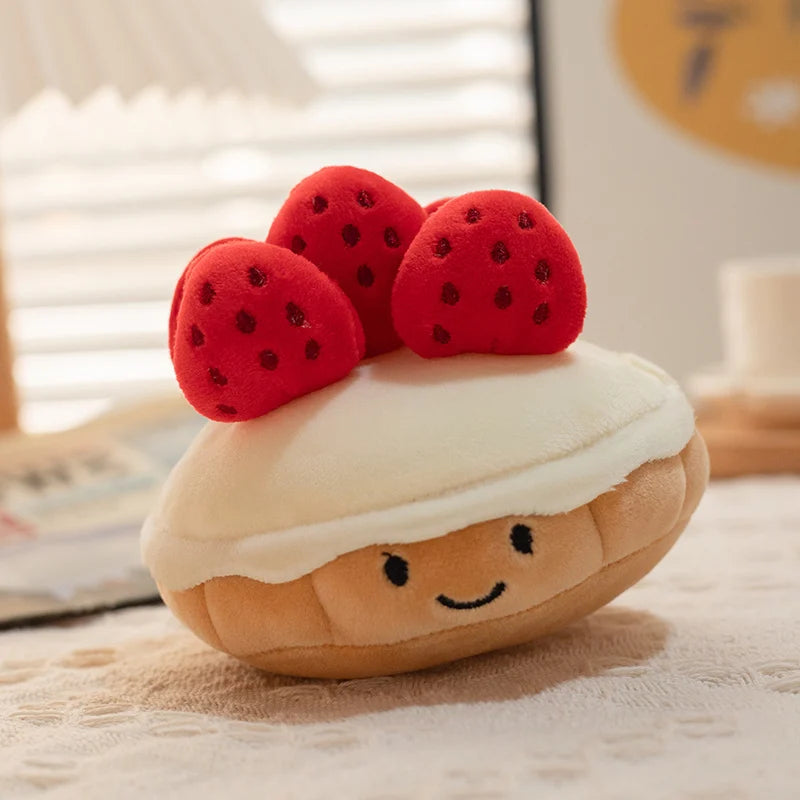 Plush kawaii toy resembling a cake with strawberry on top on a wooden surface.