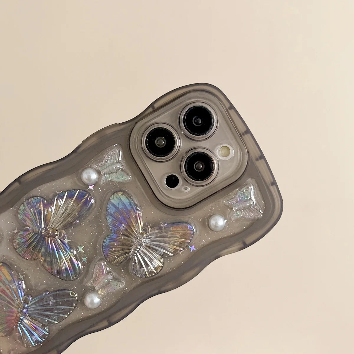 Phone case with kawaii butterfly and pearl design on a beige background