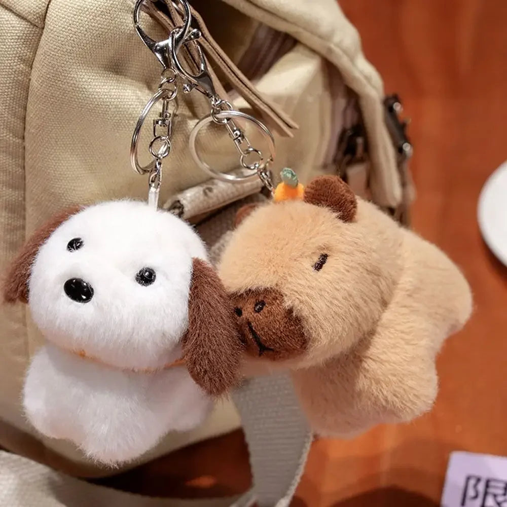 Two kawaii plush dog keychains hanging from a bag.