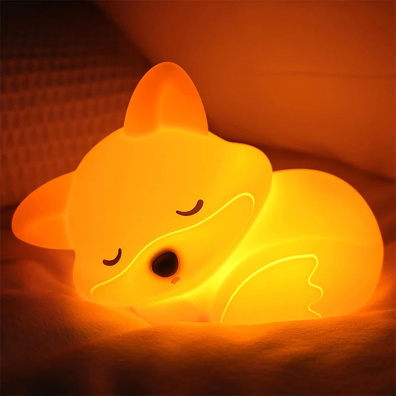 Glowing yellow fox-shaped kawaii night light on a dark background